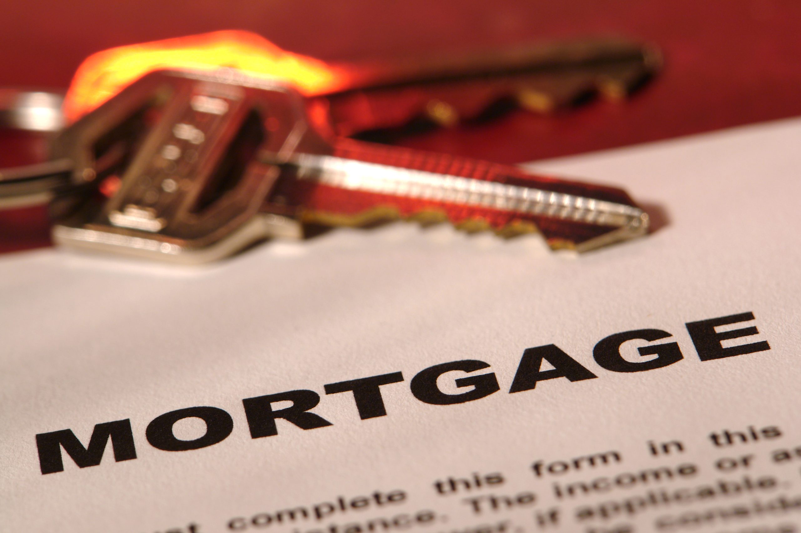 Mortgage contract papers with a set of housekeys