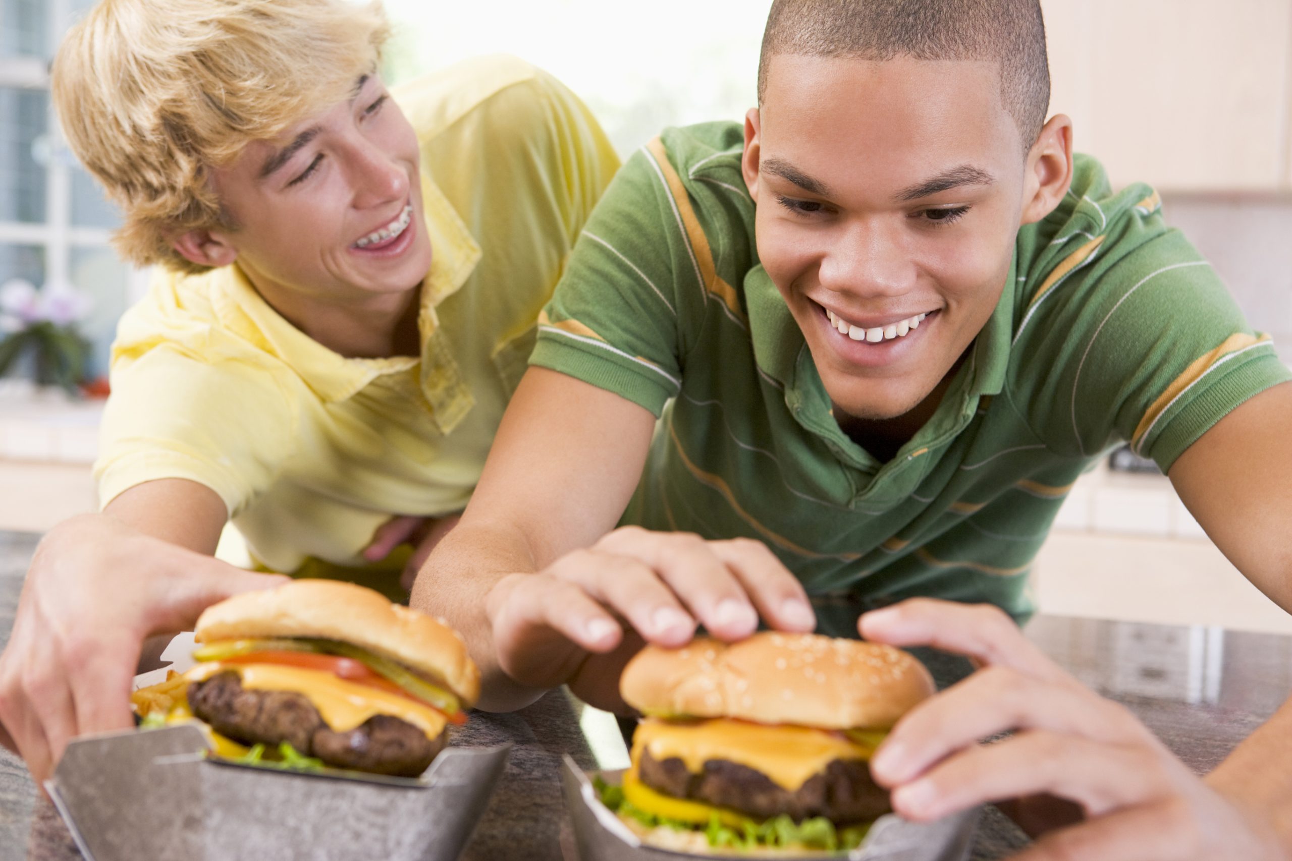 Teenagers eating burgers